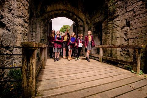 School pupils walking through the gate of Portchester Castle in Hampshire
